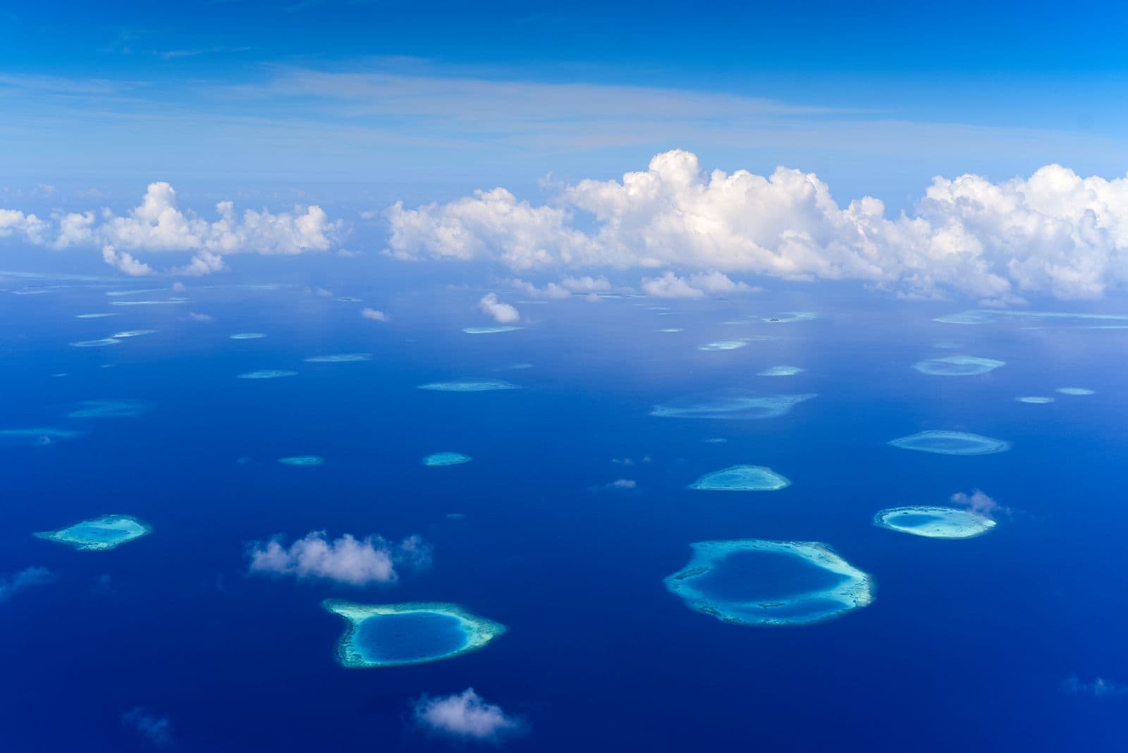Aerial view of island atolls in a turquoise ocean